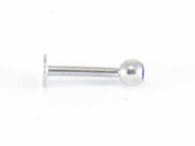 Labret-piercing med djupblå sten